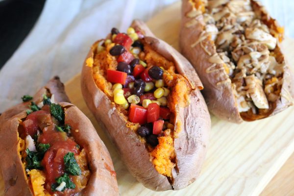 three stuffed sweet potatoes in a line on a plate