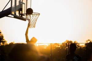Playing basketball at sunset