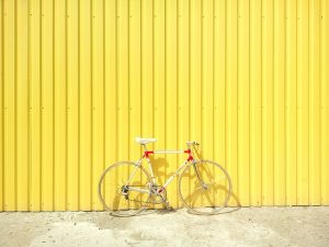 bike against a yellow wall