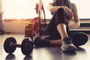 woman sitting next to weights