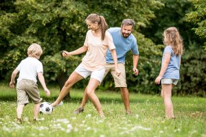 family playing soccer