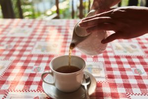 hands pouring tea from teapot