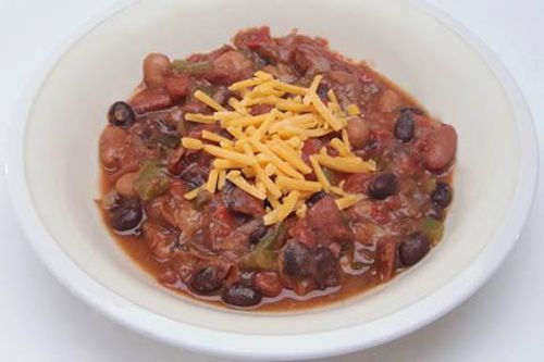 bowl of chili with shredded cheese on top