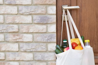 cloth grocery bag hanging on door handle 