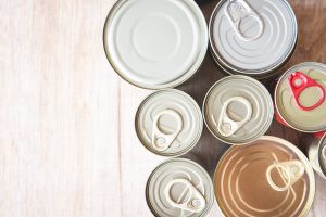 Canned food items on a wooden table