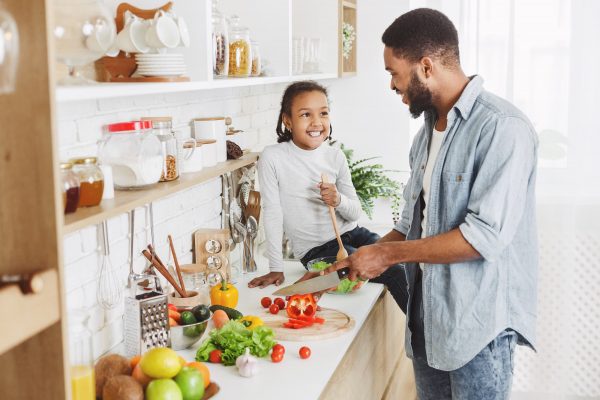 father and daughter cooking together