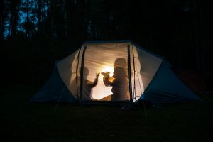 silhouettes of children playing in tent
