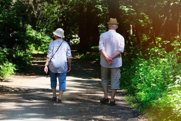 middle aged couple walking on path