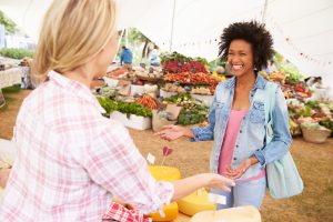 woman selling fresh cheese at an outdoor marker