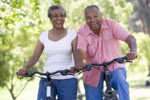 african american senior couple on bicycles