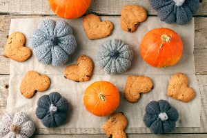 Delicious pumpkin heart shaped cookies with an autumn harvest background