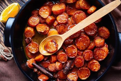 candied yams in skillet with wooden spoon