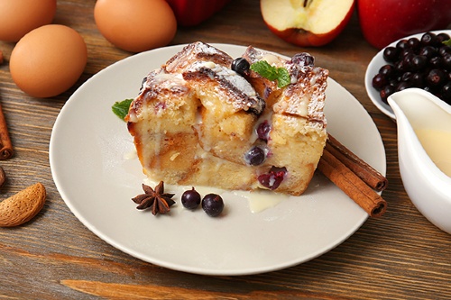 White plate with cinnamon apple bread slice on it