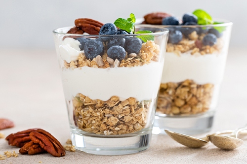 Layered glasses of cereal, yogurt, and berries