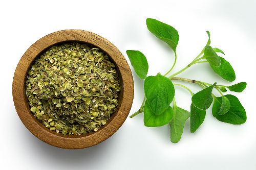 dried oregano in a wooden dish