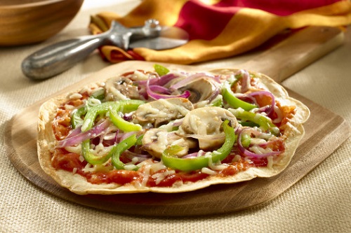 Tortilla pizza with red sauce, vegetables, and cheese