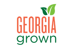 Logo that says Georgia grown in orange and green text, two green leaves over the I in Georgia