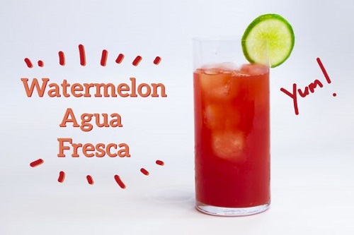 Glass of bright red drink with a lime slice next to text that reads "Watermelon Agua Fresca" and "Yum!"