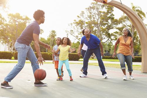 multigenerational african american family playing basketball