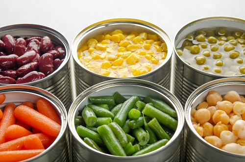 Open cans of vegetables lined up together