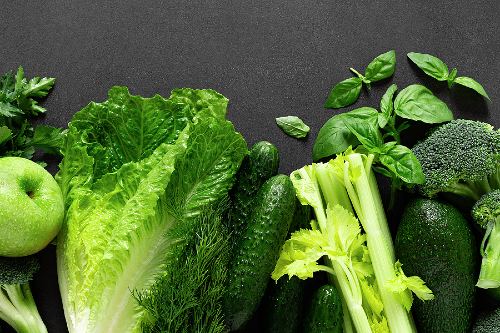 fresh green produce laid on a black surface