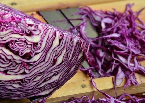 sliced red cabbage on a wooden cutting board 