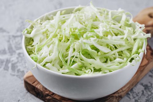 shredded cabbage in a white bowl