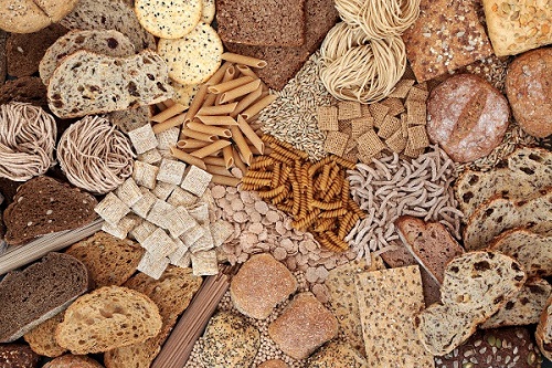 Flatlay of piles of different grain products on a surface.