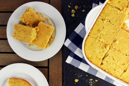 corn bread cut into squares and placed on a white dish 