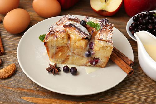 a serving of breaded apple pudding with icing drizzled over the top