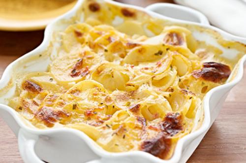 scalloped potato dish in a white serving dish