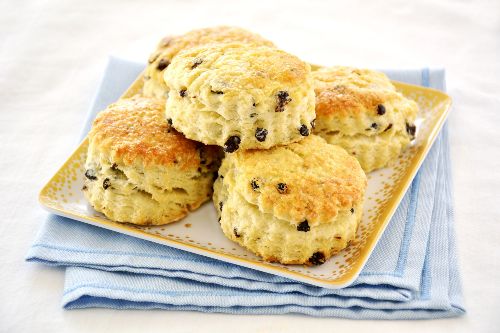 plate of scones with raisins sitting on top of light blue napkins
