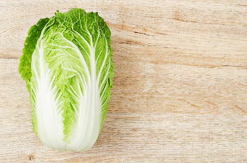 Chinese cabbage lying on a wooden surface 