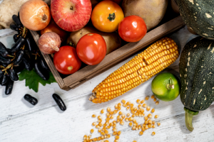 corn, tomatoes, squash, and other seasonal produce on a table