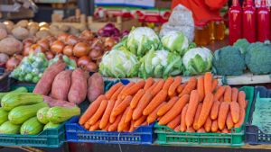 variety of vegetables in baskets at a farmers market