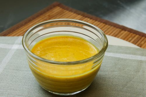 Yellow curry salad dressing in a glass bowl 