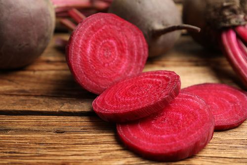 sliced beets on a wooden cutting board