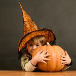 Child holding pumpkin