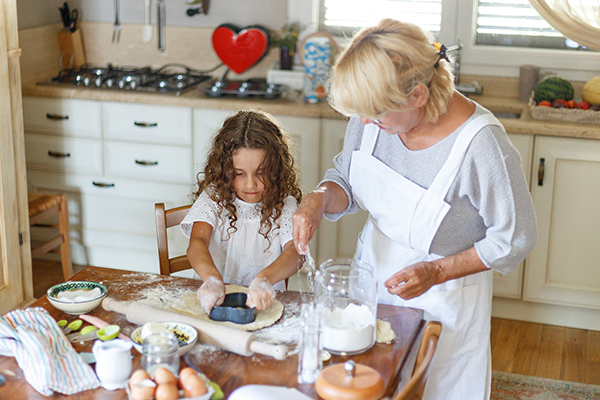 little girl helps grandma in the kitchen.