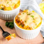 Homemade breakfast casserole with egg, kale, and sweet potatoes sitting on a cutting board