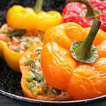 Colorful bell peppers baked and stuffed with a vegetable and rice mix