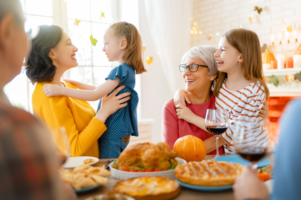 Family sitting at the table and celebrating holiday.