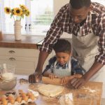 African American father and son baking together