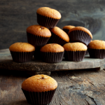 Pile of muffins on wooden board