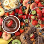 assorted fruit with fudge sauce in glass bowl