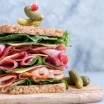 Big sandwich stack with ham, deli meat, cheese and vegetables