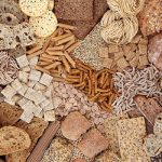 Flatlay of piles of different grain products on a surface.