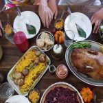 people sitting at a table with holiday foods