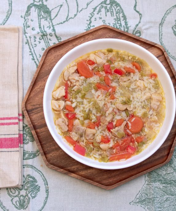 bowl of split pea soup on a table with utensils